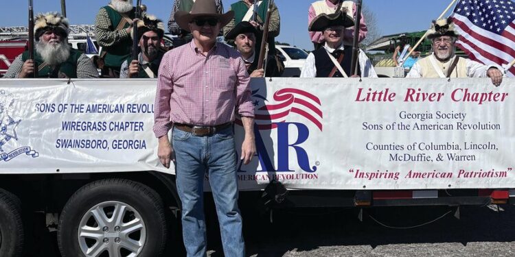 Skunk Brigade rides in Annual Livestock Parade