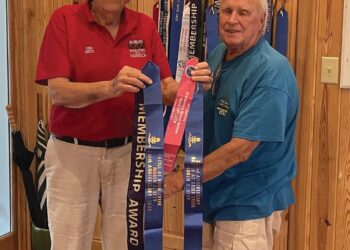 Smith presents Flag Streamers to Carr