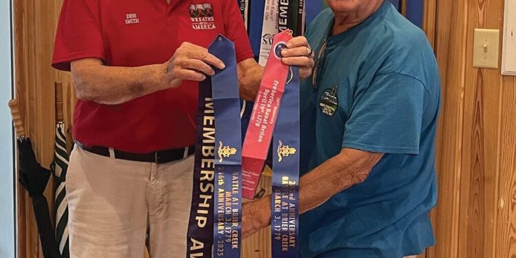 Smith presents Flag Streamers to Carr